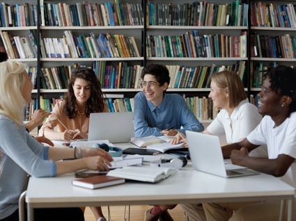 Image of group of college students working together in a library